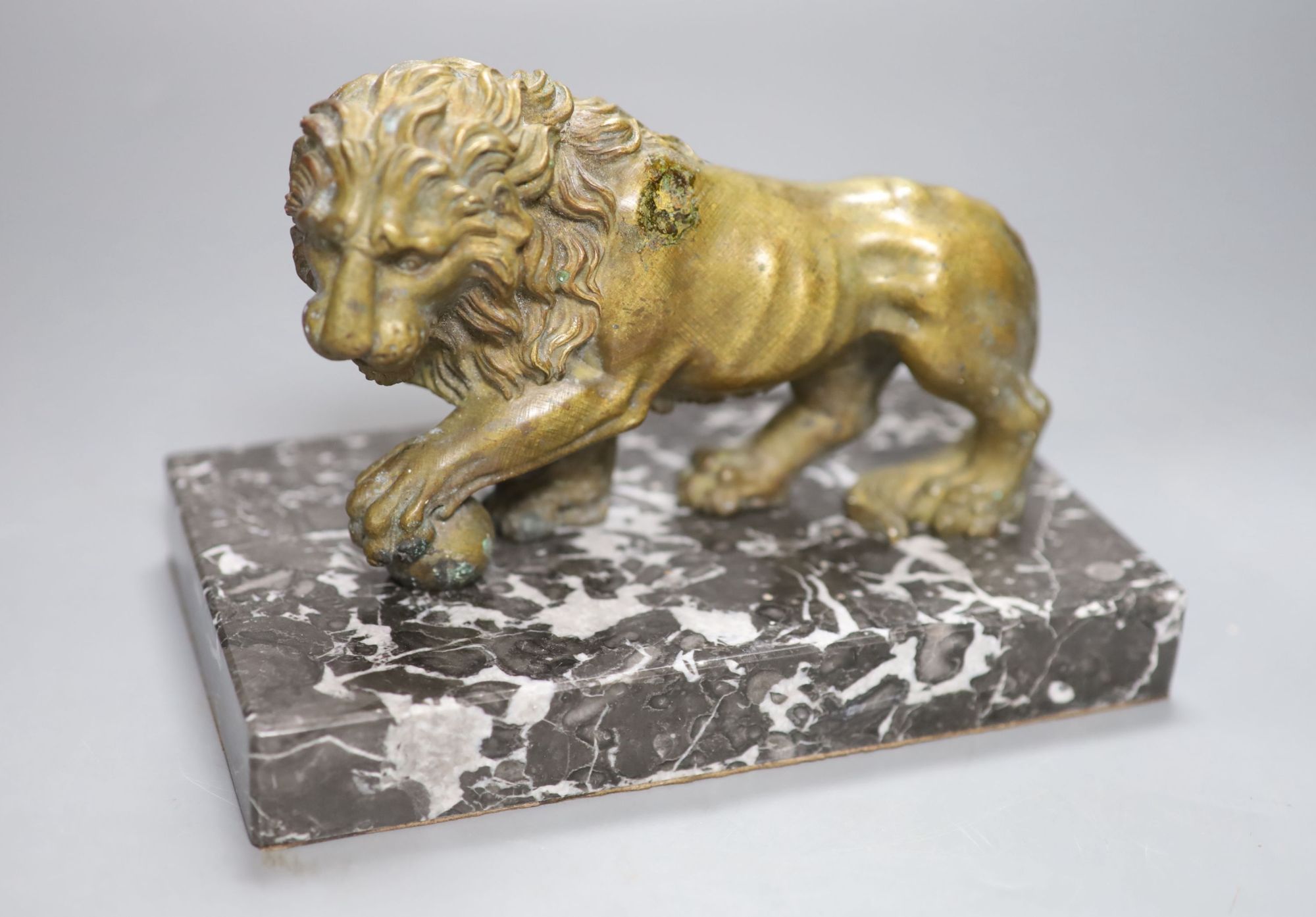 A 19th century bronze of a lion on a marble base, length 19cm